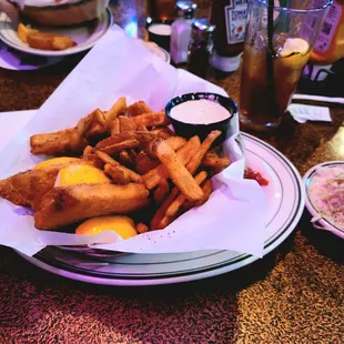 a basket of fried fish and fries