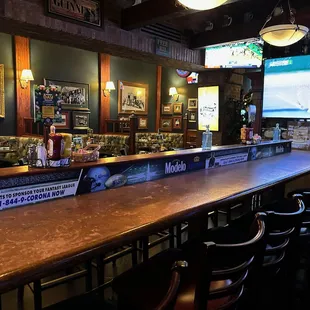 More seating area at a long table by the big screen TV.