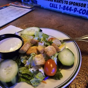 a plate of salad with dressing