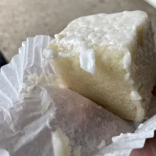 a hand holding a piece of cake