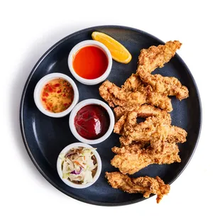 Chicken Strips - buttermilk marinated chicken thigh, coated in crisp breading. Includes 3 house-made hot sauces.