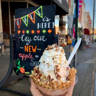 a hand holding a cone of ice cream