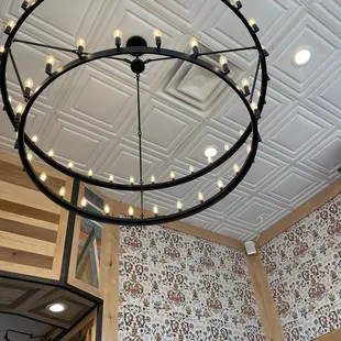 a circular chandelier hanging from the ceiling