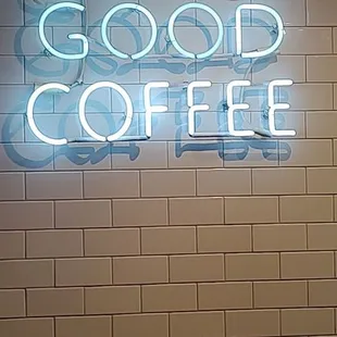 a neon sign that reads drink good coffee