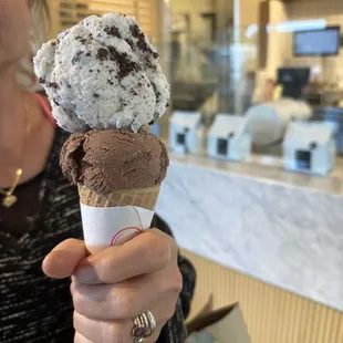 cookies and cream ice cream and chocolate ice cream on a sugar cone