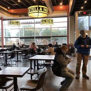 people sitting at tables in a restaurant