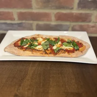 a flatbread pizza on a plate