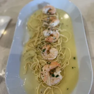 a plate of pasta with shrimp