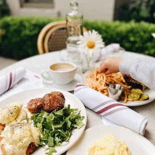 two plates of food on a table outside