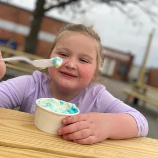 a little girl eating ice cream