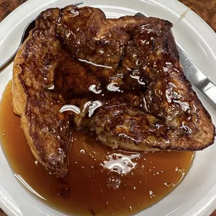 French toast 2 huge homemade bread seasoned by the cook. (syrup is on the table.) We personally like to drown ours.