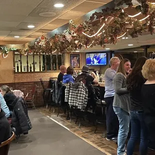 a group of people sitting at a bar