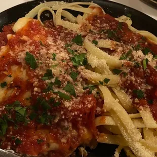 a plate of pasta with sauce and parmesan cheese