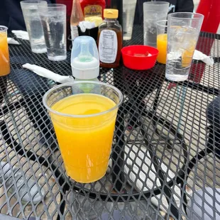 a glass of orange juice on a table