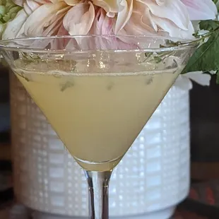 a martini with flowers in the background