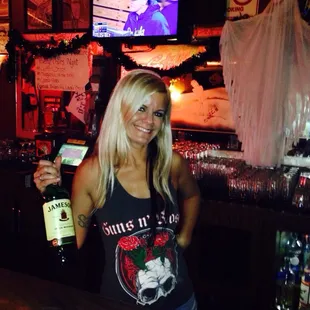 a woman holding a bottle of beer