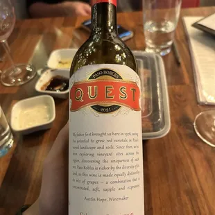 a person holding a bottle of wine