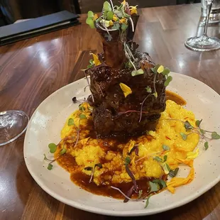 Pork shank on a bed of saffron risotto.