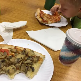 Slices of cheese and white pizza with a whole bushel of mushrooms