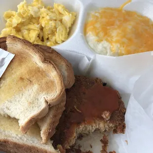 a tray with a sandwich, scrambled eggs, and macaroni and cheese