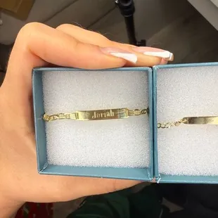 Crooked (the letter H almost touching the top of the bracelet) Fingerprints still on the jewelry, they are also scratched and bent.