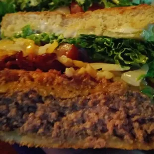 The Timmy Burger (beef patty, hot sausage patty, bacon, and cheese)