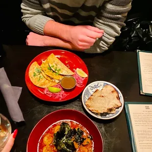 a man sitting at a table with plates of food