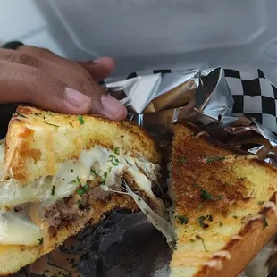 Cheese pull on the Steph&apos;s Way burger.