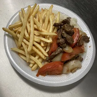 Lomo saltado with rice and French fries  Lomo saltado con arroz y papas fritas