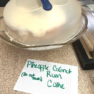 a frosted cake with a blue spatula on top