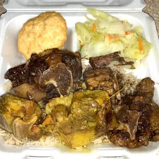 Oxtails with rice, cabbage, and a fried dumpling.