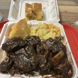 Jerked Oxtail over rice with cabbage and cornbread
