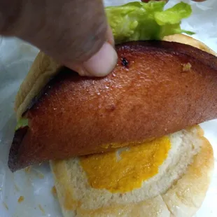 Bottom bun of mayo and mustard on Fried Bologna sandwich