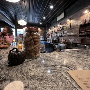 a bar counter with wine glasses on it