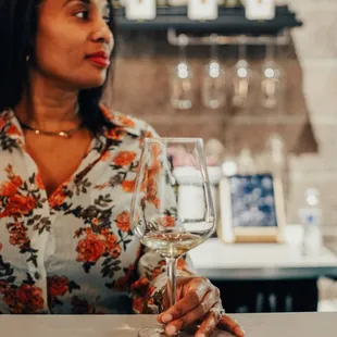 a woman holding a glass of wine