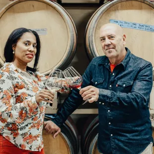 a man and woman holding wine glasses