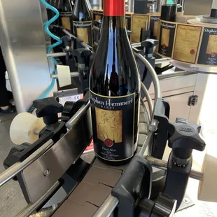 a bottle of wine on a conveyor belt
