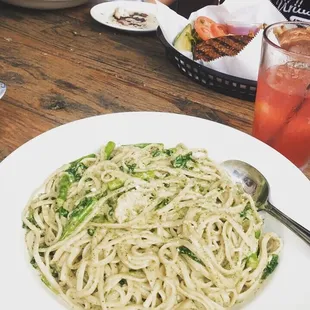 a plate of spaghetti and a glass of juice