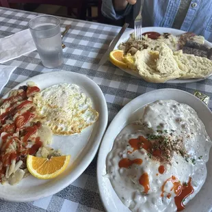 Classic sausage two egg breakfast in the back and biscuits and gravy.