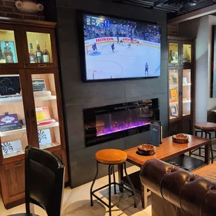 a man watching a hockey game on tv