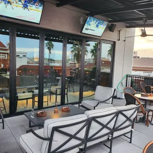 patio with seating and flat screen tvs