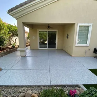 a concrete patio with artificial grass