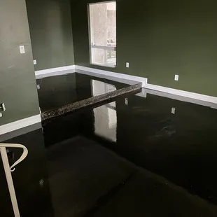 Living room and office with painted walls and stained and sealed cement