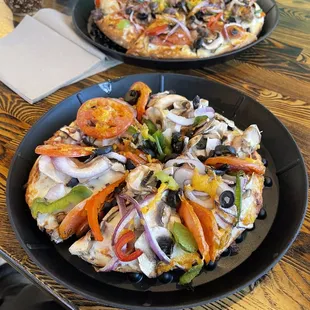 Veggie pizza with chicken, wings and salad.