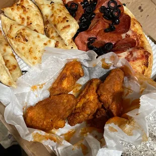 Pepperoni and olive pizza, breadsticks, and Wings