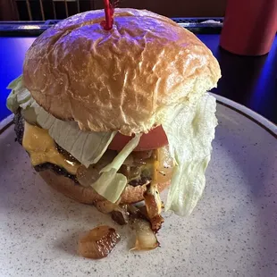 Single cheeseburger with onions pickles and tomatoes