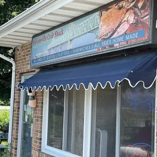 Entrance, and picnic tables under shade