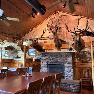 a dining room with deer heads on the wall
