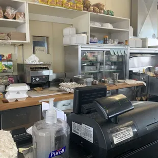 In front of counter seats, cook too in view.