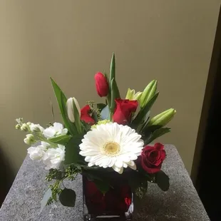 Red and white mixed flowers in red cube vase